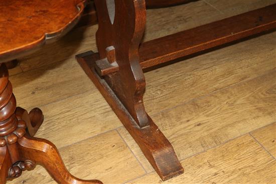 An oak refectory table, with trestle end supports, W.206cm